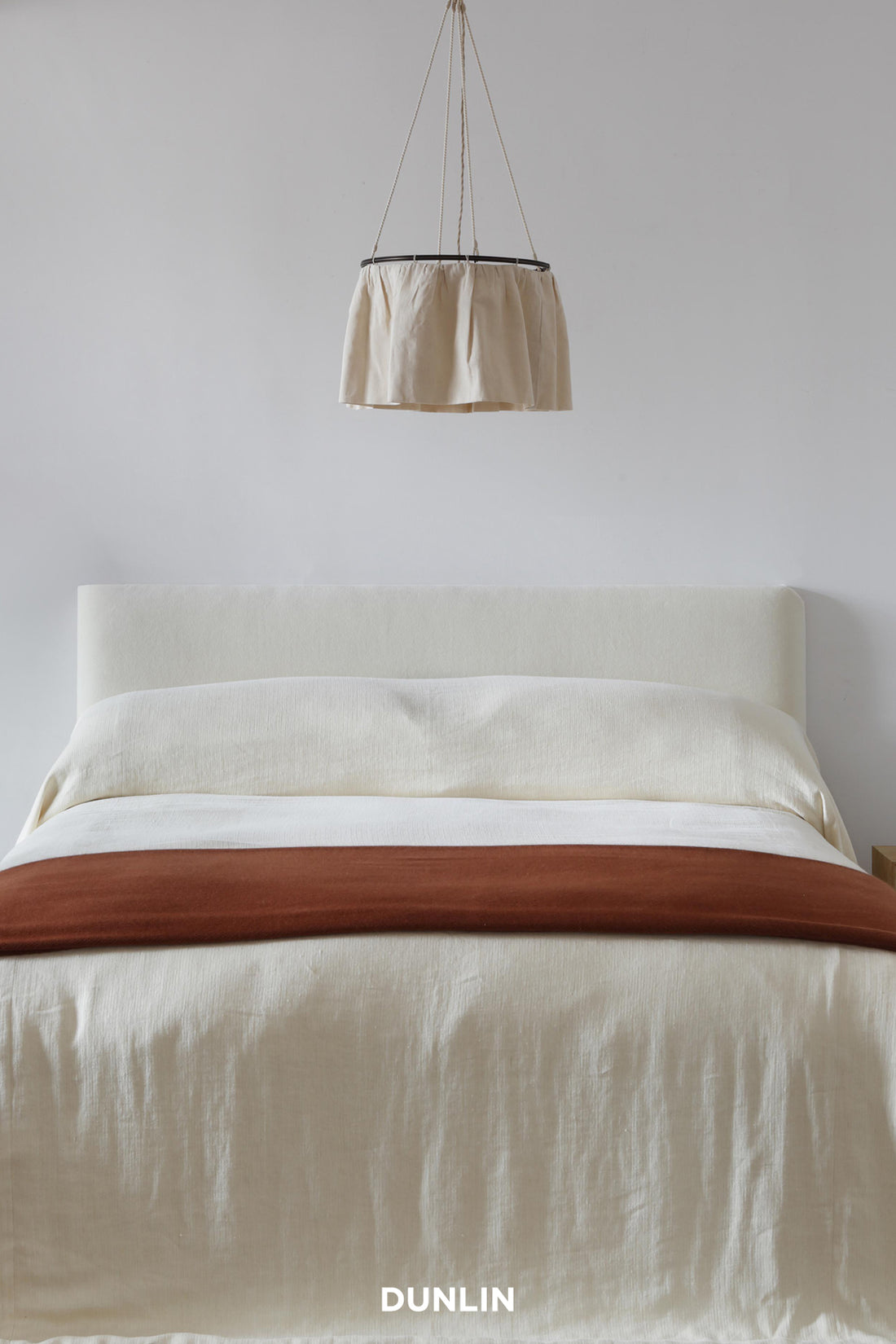 Skirt Pendant Light, Large by Rose Uniacke over bed at Dunlin