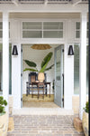 Front door of a house with a plant and chair inside, featuring the brand 'Dunlin'.