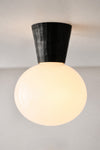 Dunlin weathered brass Facet Light turned on with opal glass