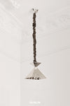 A nickel plated brass pendant light with a scrunch design, hanging from the ceiling.