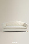 An off-white tufted loveseat sofa with a curved backrest and small wooden legs, shown against a plain beige studio background with the brand name DUNLIN at the bottom.