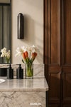 DUNLIN Decade Linear wall light in a warm marble and timber bathroom interior
