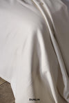 Rose Uniacke Bedspread in Pearl Wool at Dunlin