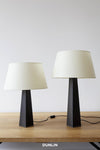 Rose Uniacke Leather Table Lamps with natural parchment shades, available from DUNLIN Australia.