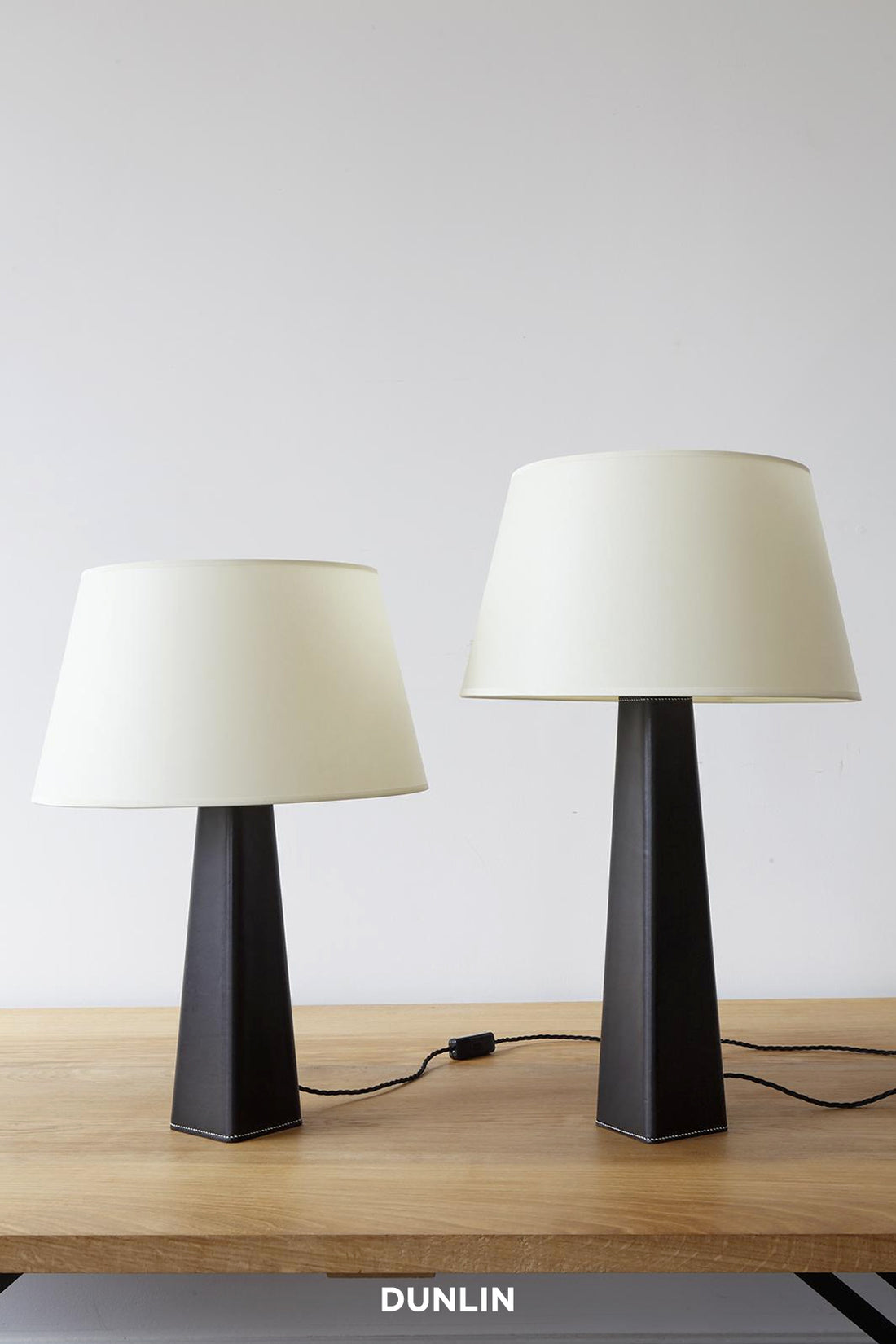 Rose Uniacke Leather Table Lamps with natural parchment shades, available from DUNLIN Australia.