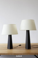 Rose Uniacke Leather Table Lamps with natural parchment shades, available from DUNLIN Australia.